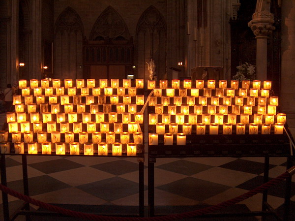 candle light warming up the cold and dark church walls