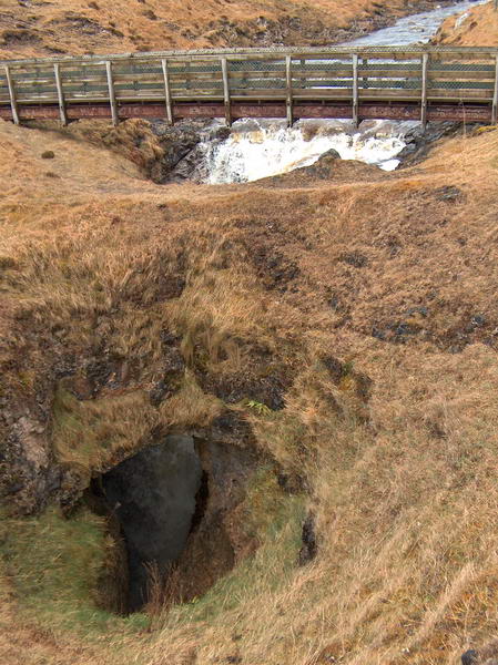 Above the cave a creek suddenly drops right into it